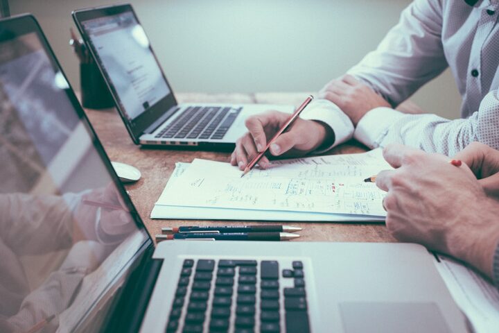 Desk paperwork and laptop — records matter as much as the contract read when you petition an issuer.
