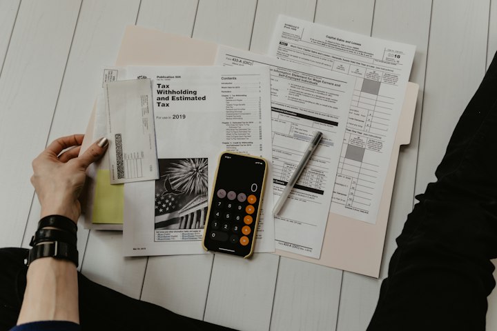 Laptop with financial documents — issuer tickets are a records process.